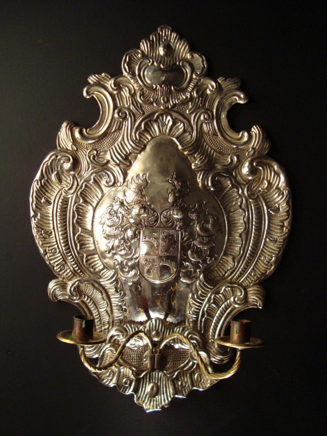 A silvered brass armorial wall light