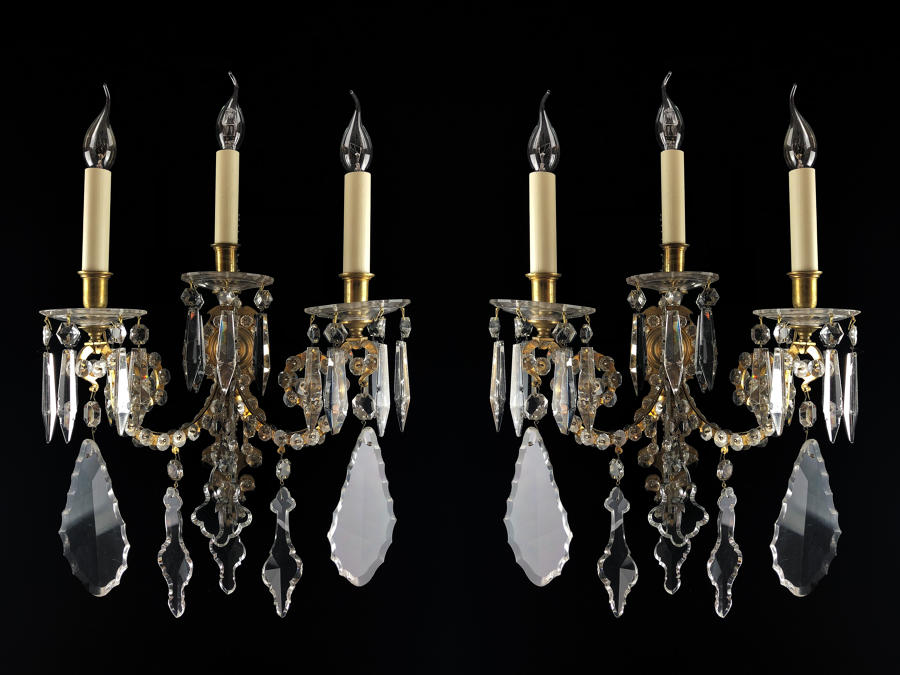 A large pair of cut glass wall lights