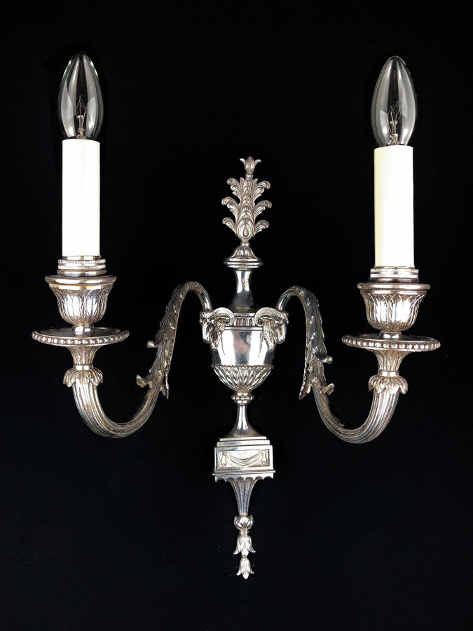 A single two arm silvered wall light
