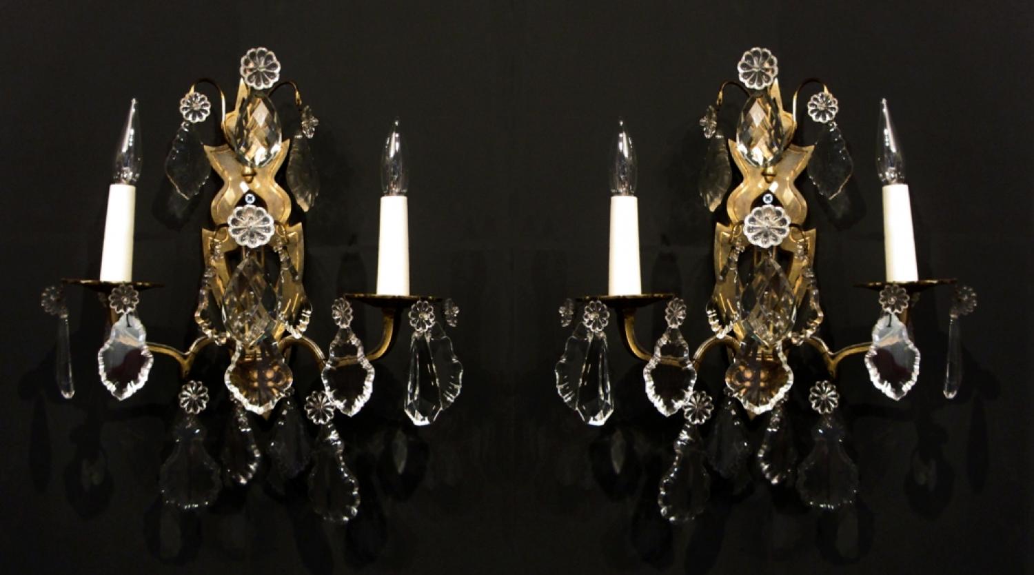 A pair of gilt and crystal wall lights