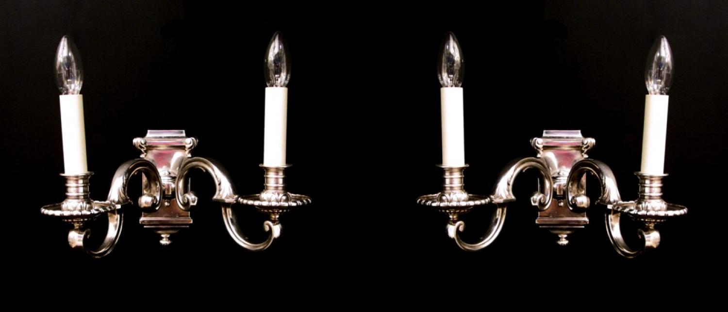 A pair of silvered brass two arm wall lights