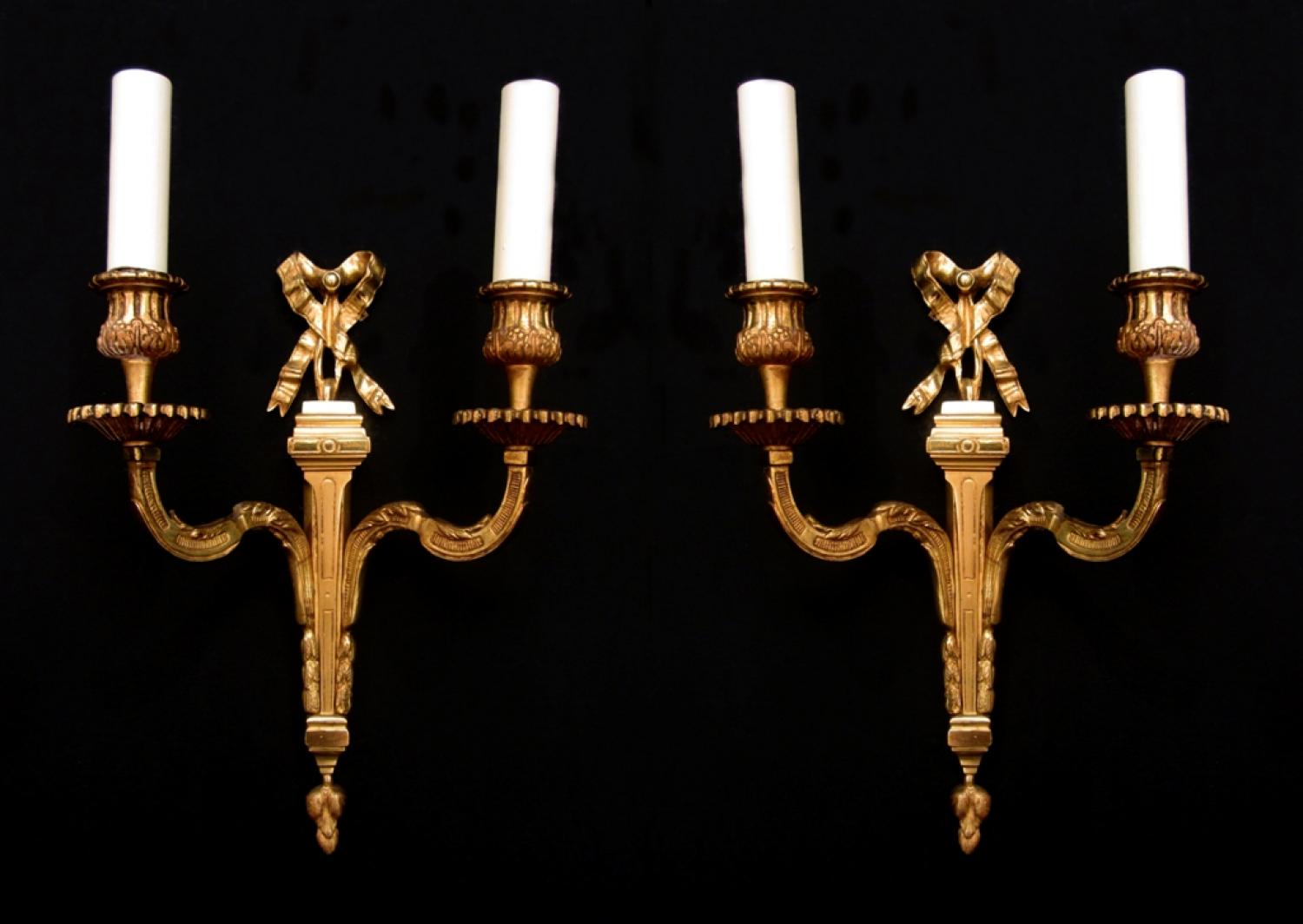 A pair of Louis XVI style brass wall lights