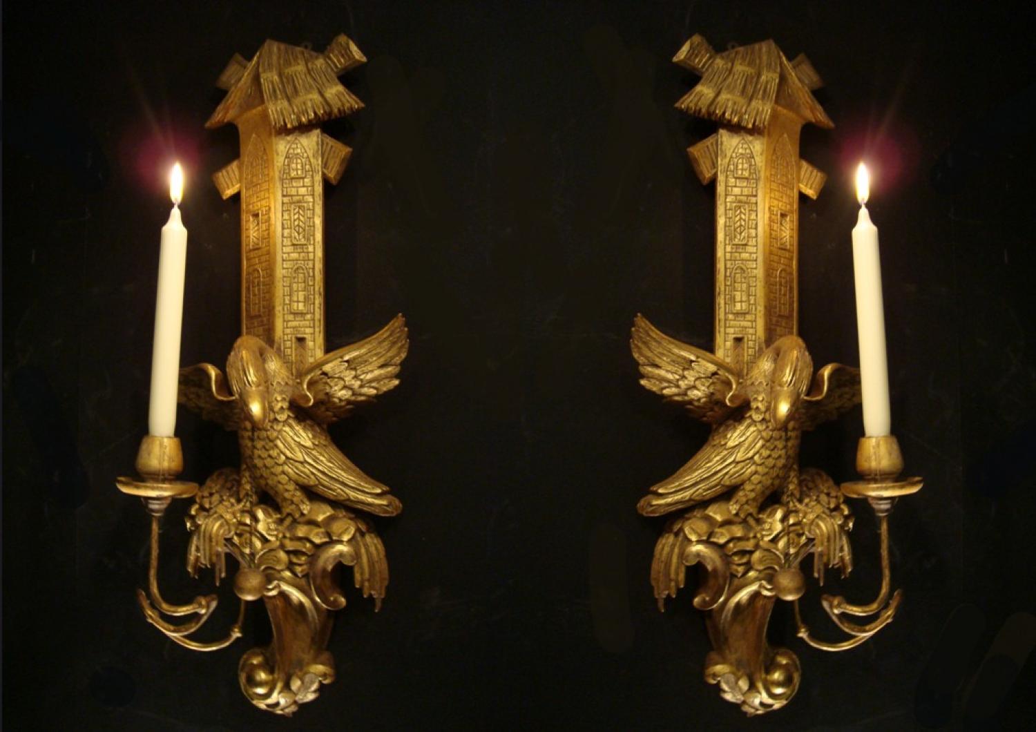 A pair of carved gilt wood wall lights
