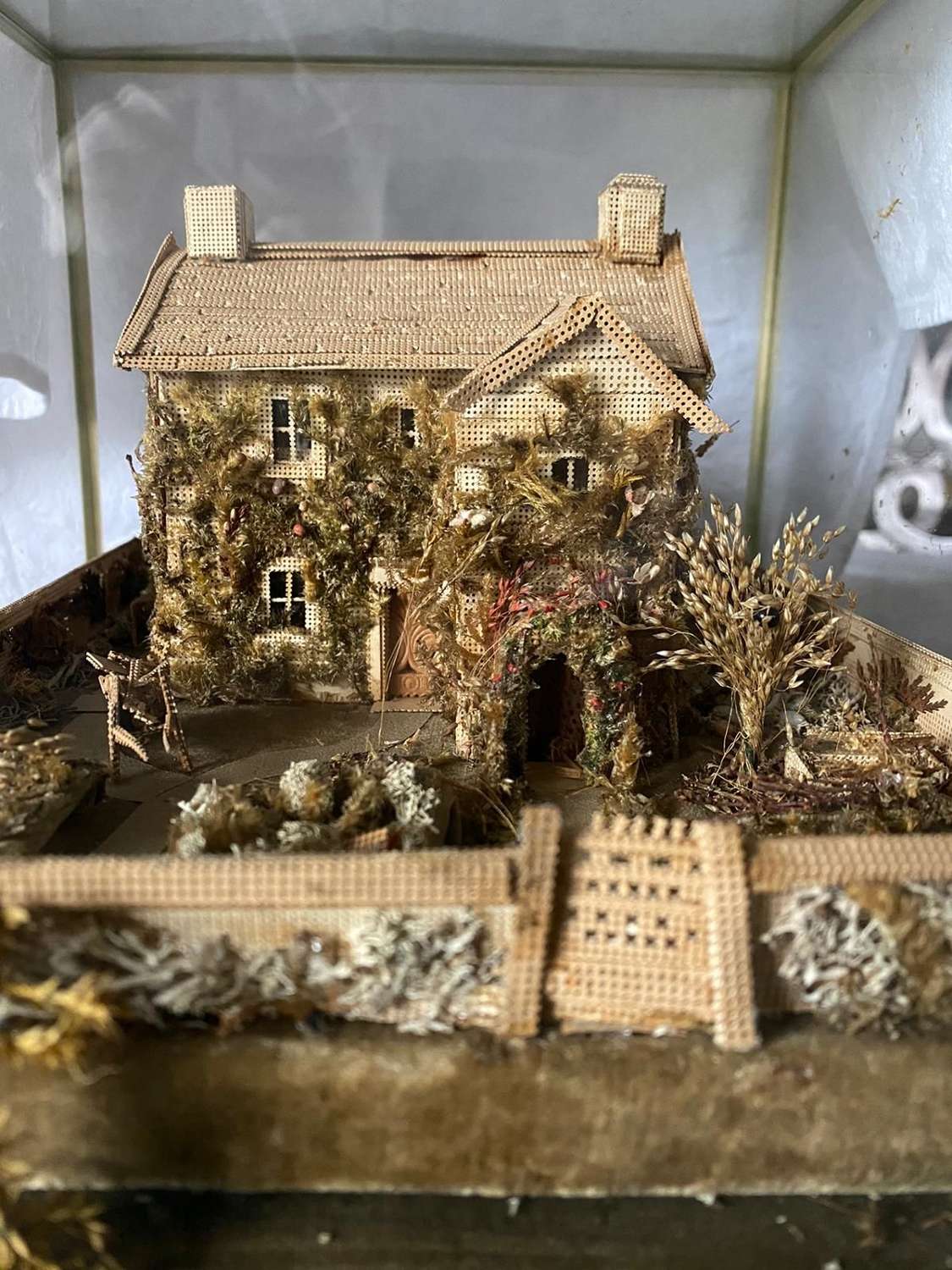 A model of a cottage Made of pinpricked wood