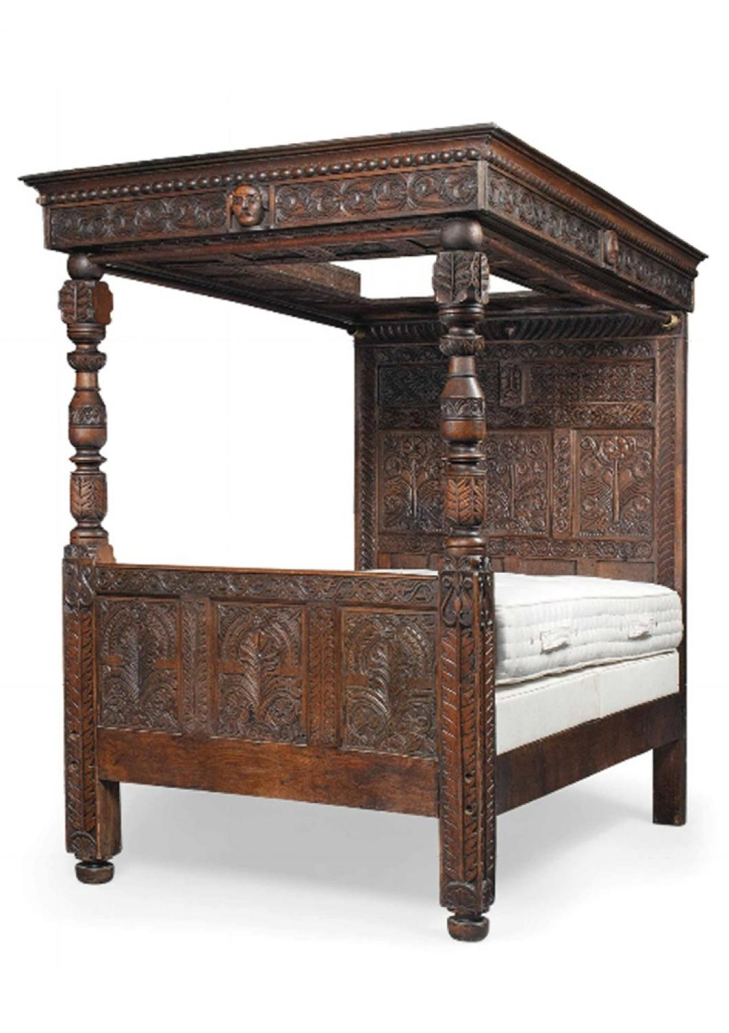 An Englsih carved oak four tester bed