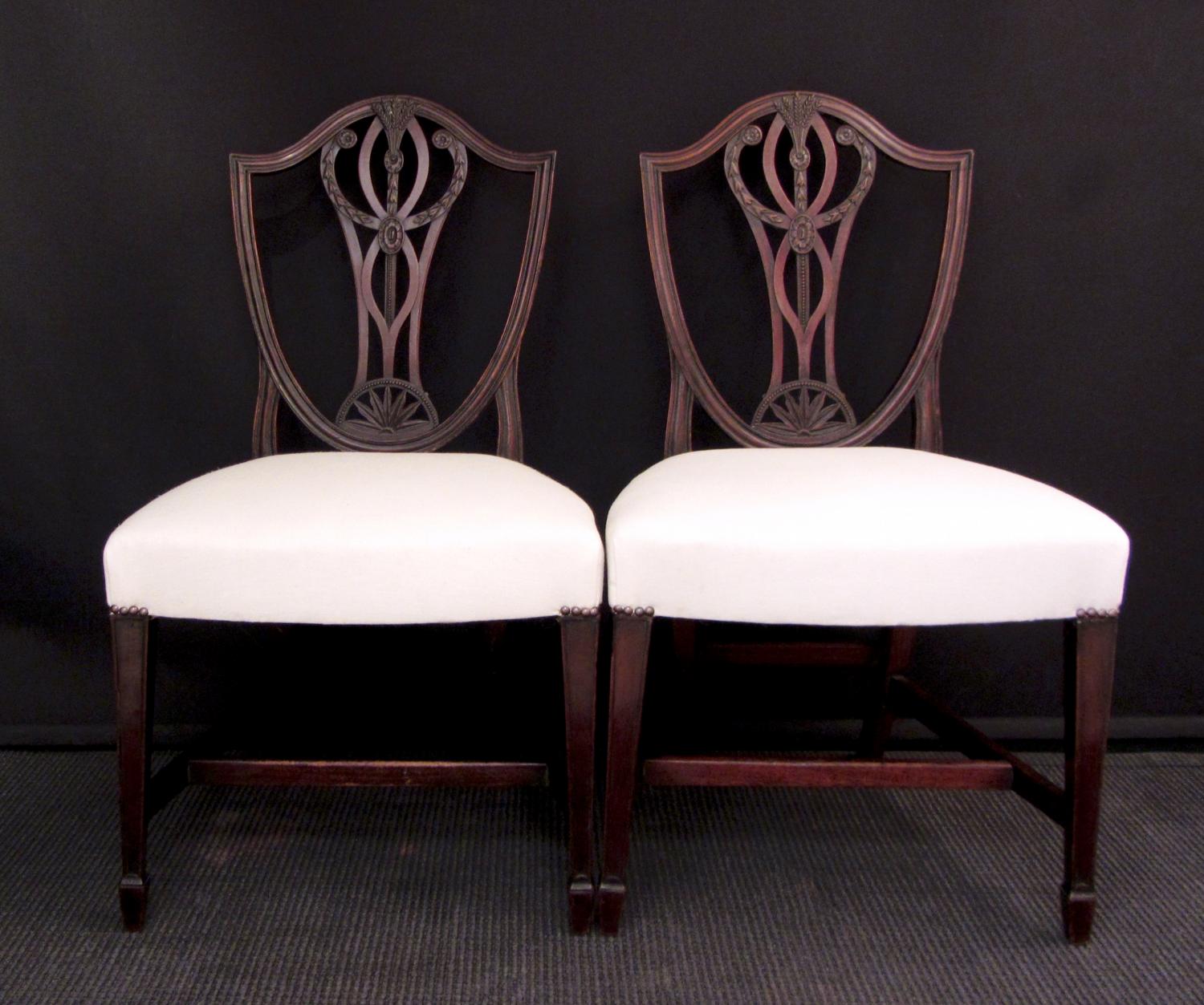A set of eight carved mahogany dining chairs