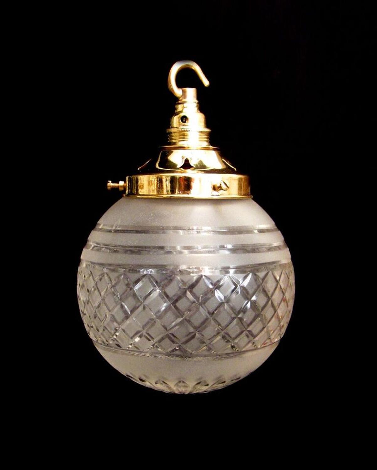 A frosted cut glass globe light