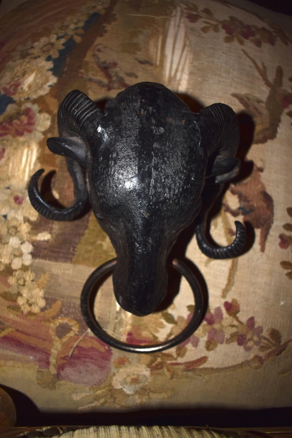 A bronze head of a ram