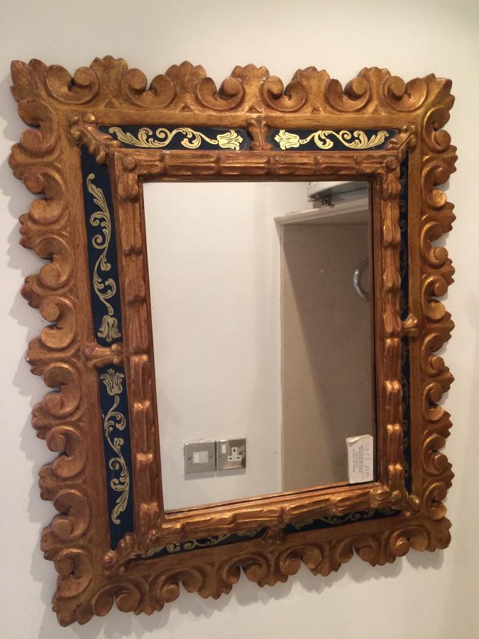 A Small Carved Wood And Gilded Mirror