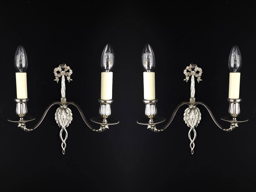A pair of silvered Louis XVI style wall lights