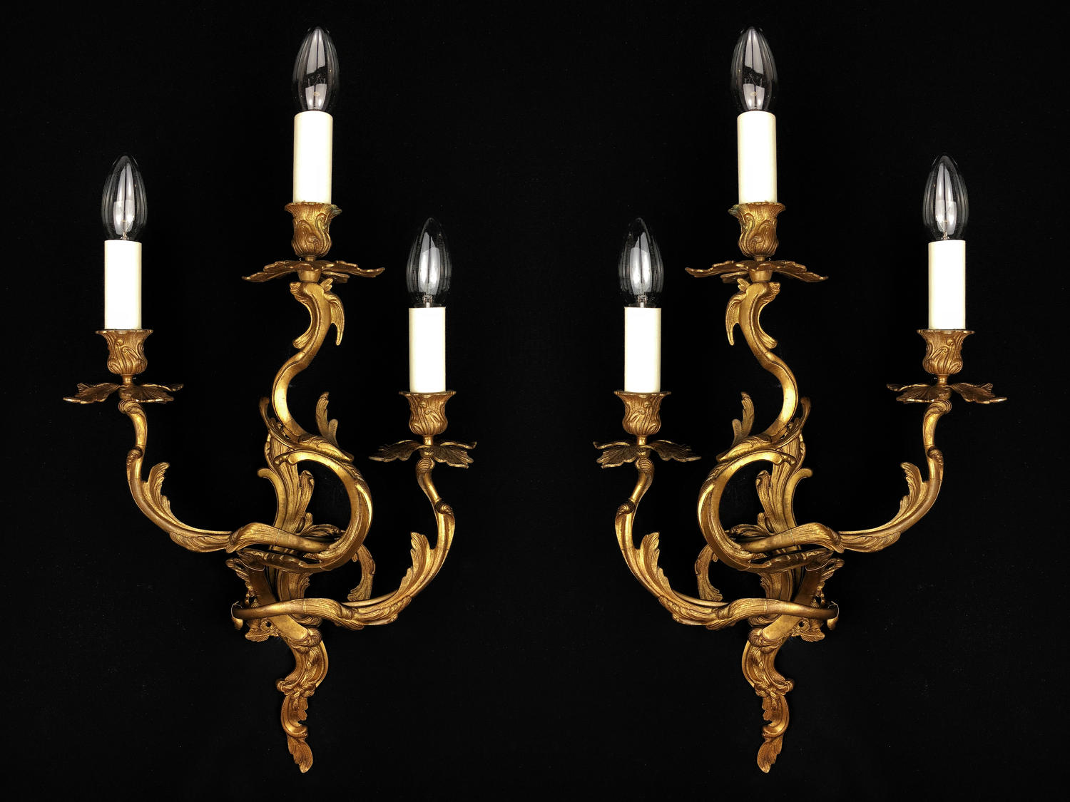 A pair of three arm Louis XV style wall lights