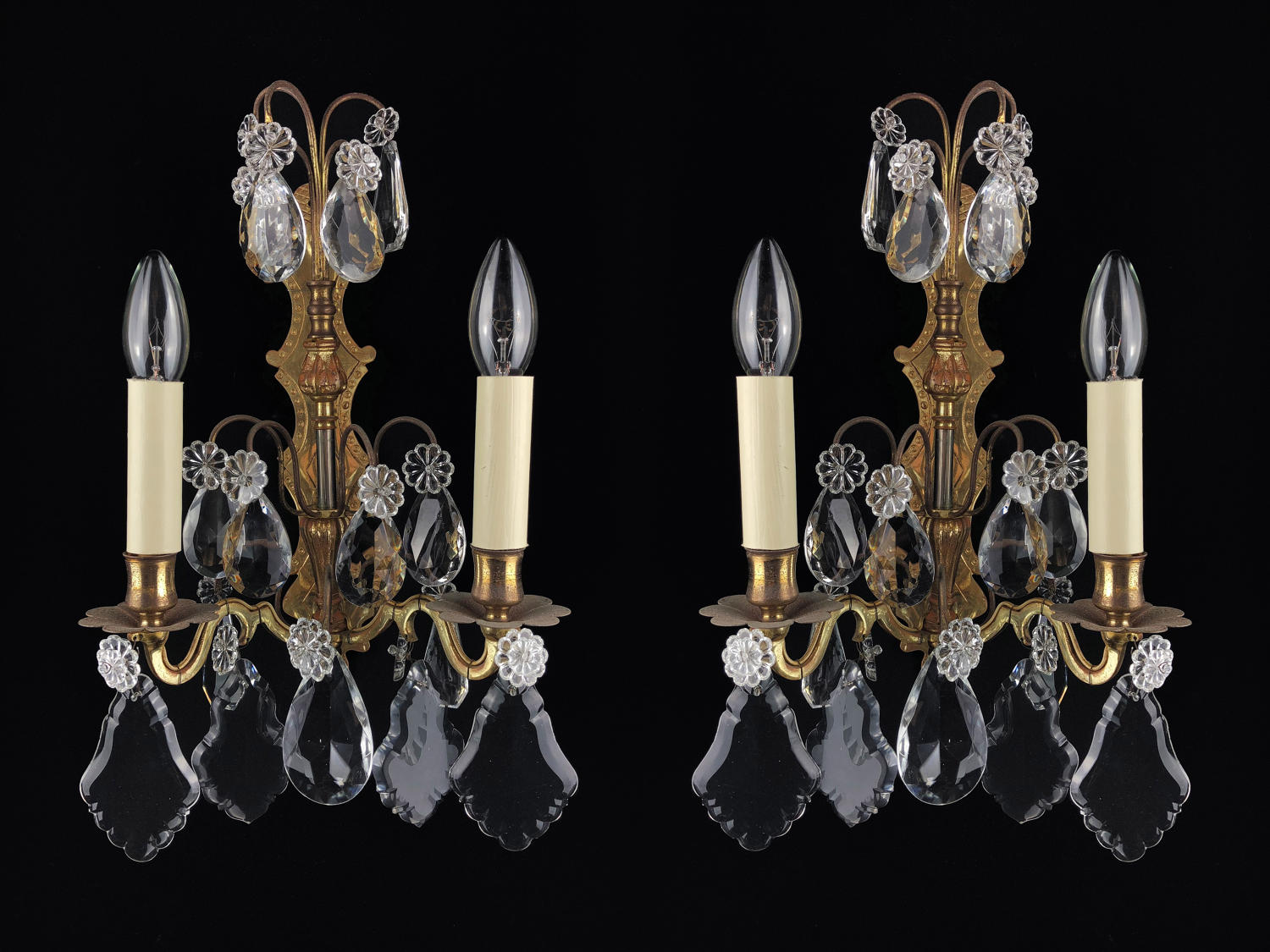A pair of gilt and crystal wall lights