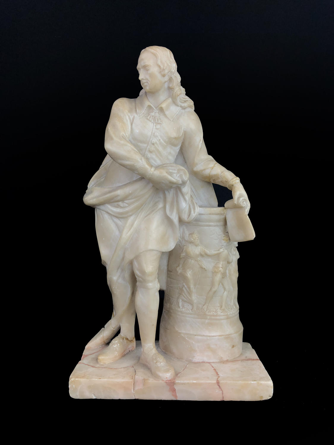 A carved alabaster figure of John Milton