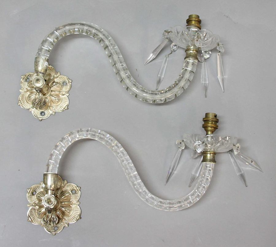 A pair of single arm glass wall lights