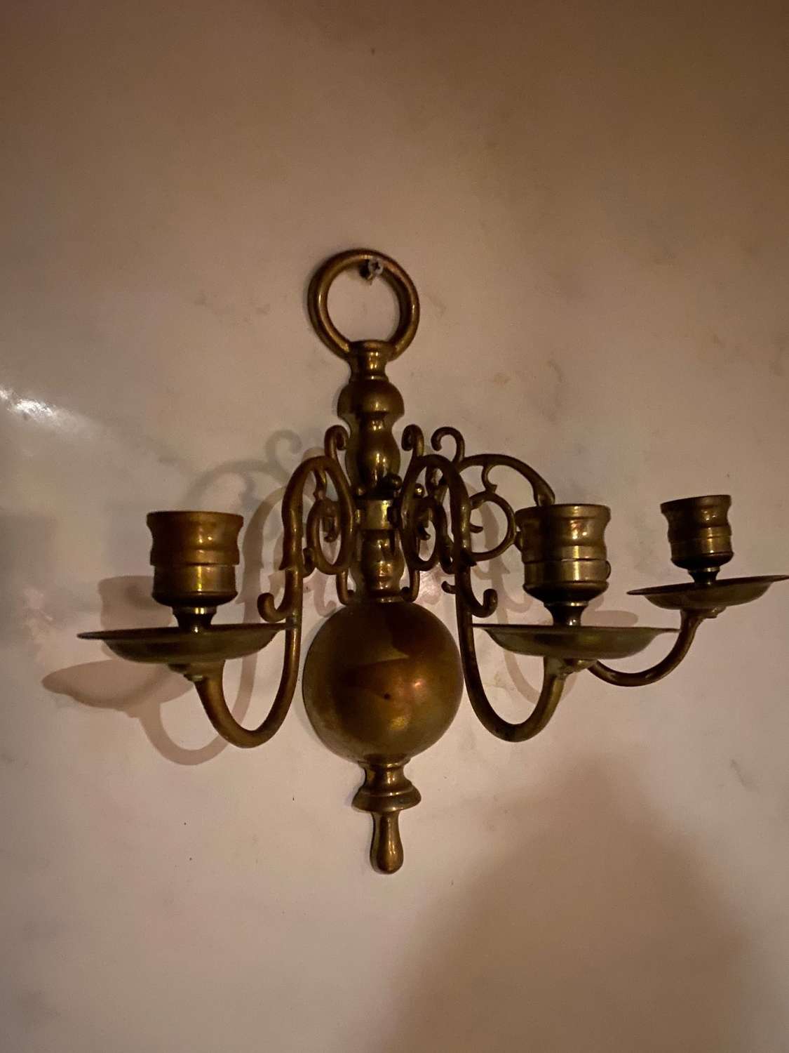 A pair of three branch Dutch style wall lights