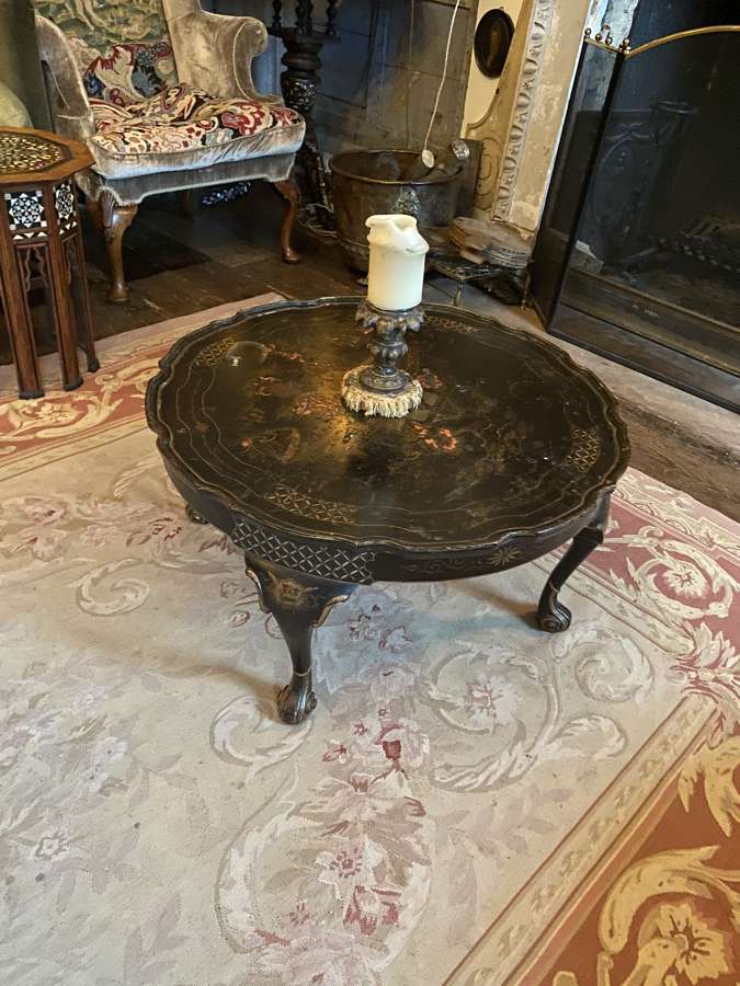 A Chinoiserie black circular coffee table with cabriole legs