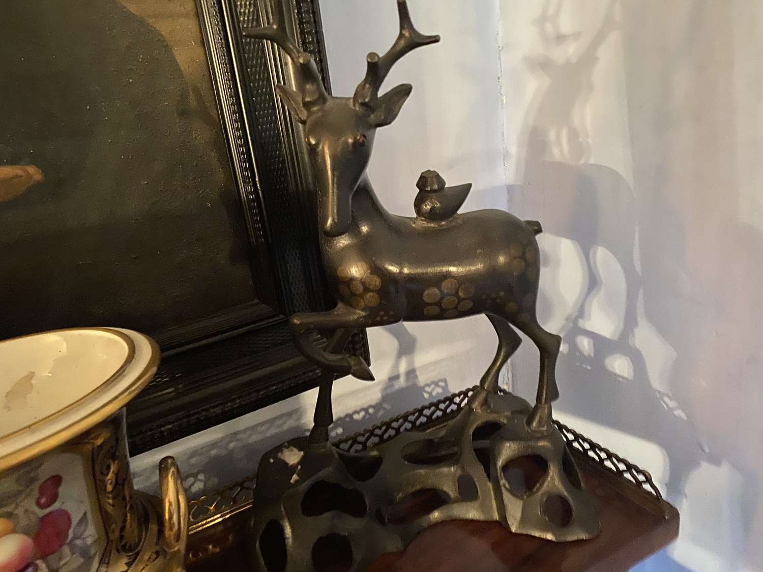 A Chinese bronze stag on pierced base