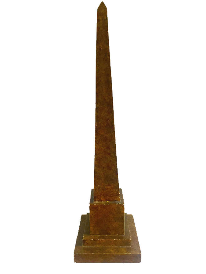 A carved wooden model of a four sided obelisk