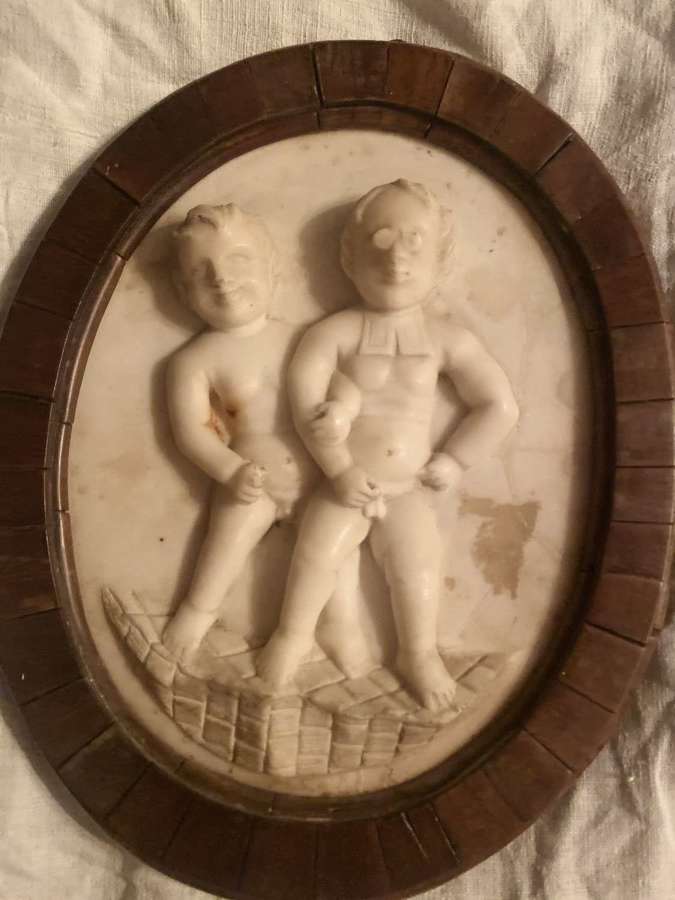 An 18th Century marble plaque of two boys walking the church