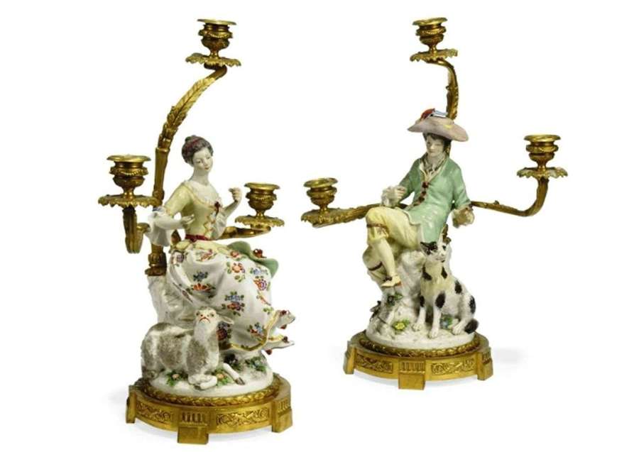 A pair of French ormolu mounted porcelain three light candelabra