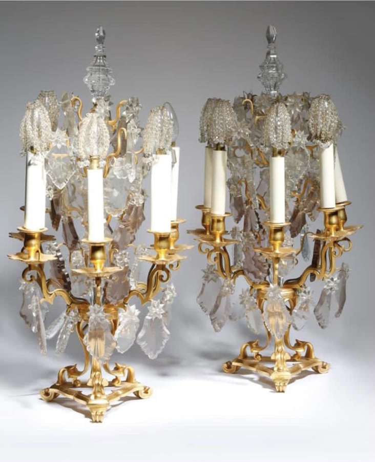 A PAIR OF GILT METAL AND GLASS FIVE-LIGHT CANDELABRA