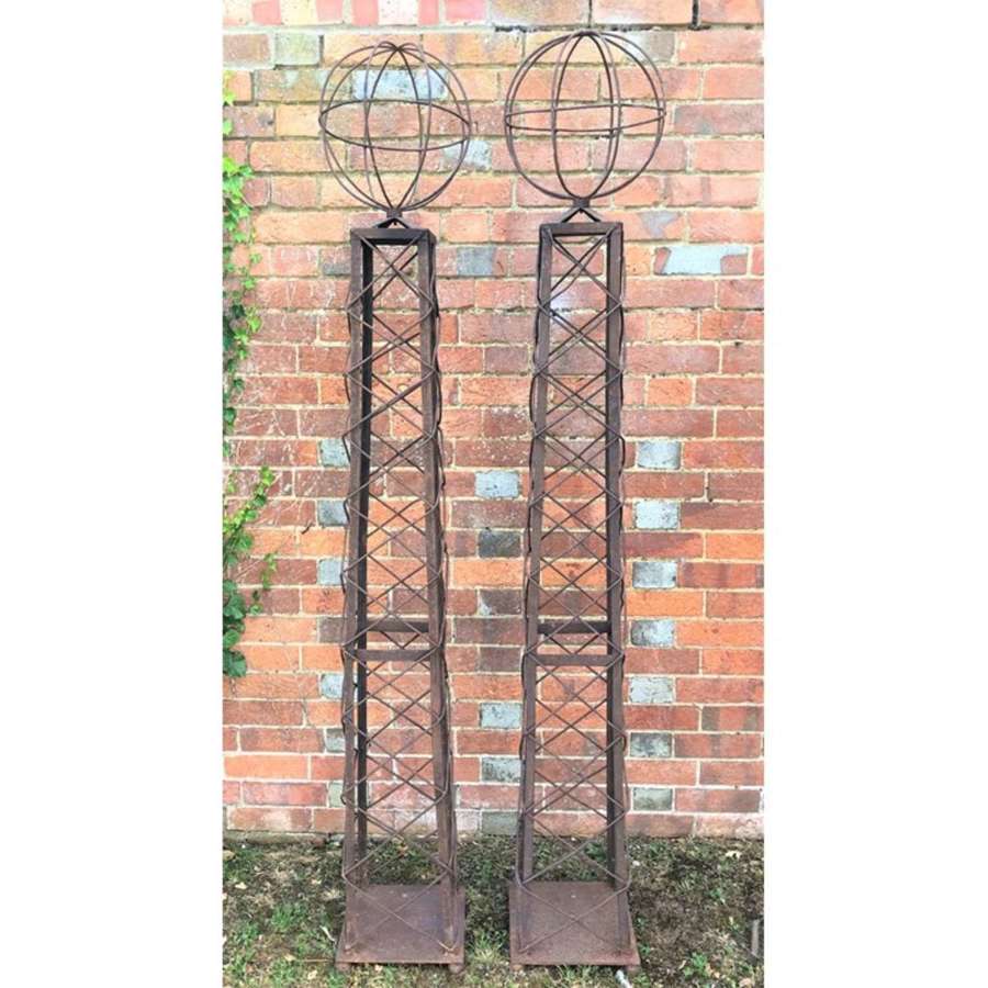 A pair of decorative wrought iron garden obelisks