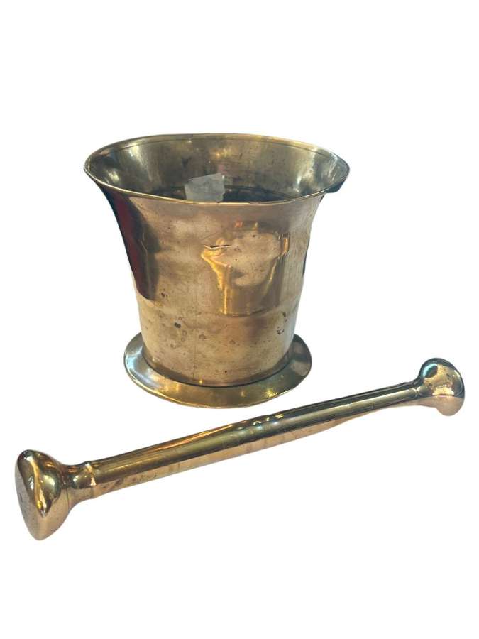 A solid brass pestle and mortar
