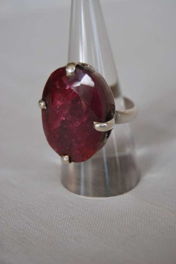 A ruby oval cut ring set in silver