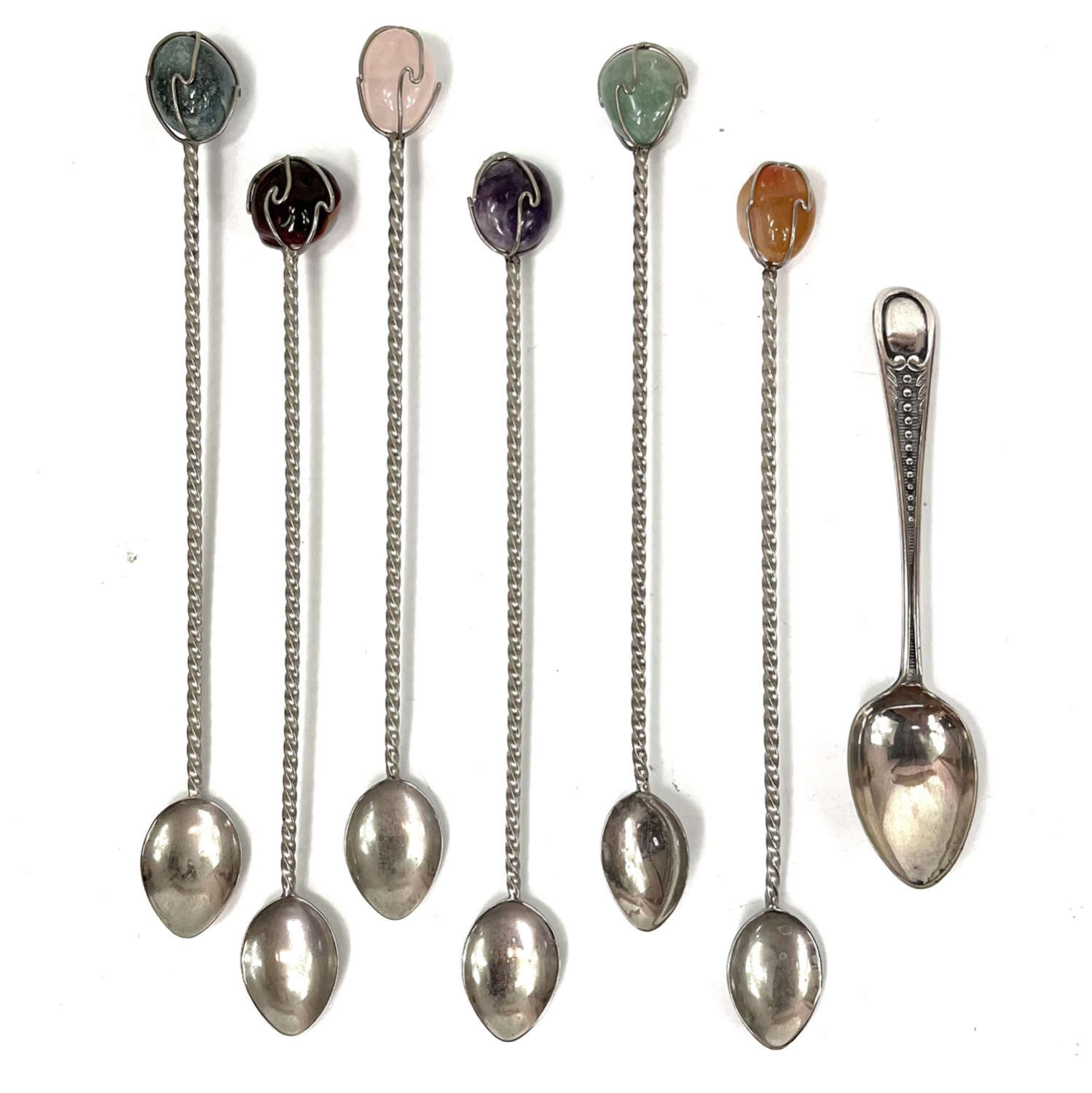 A set of six cocktail spoons and one silver spoon