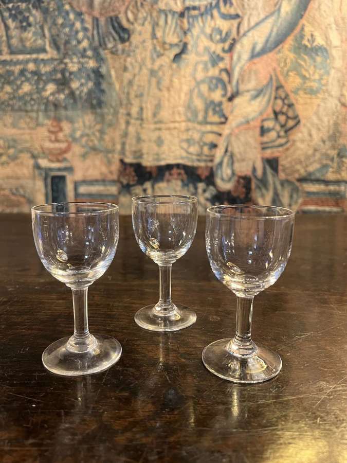 A set of three small sherry glasses